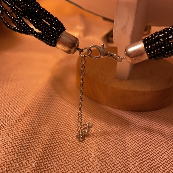 Black multi stranded beaded necklace with silver cross pendant. - Picture 3 of 6